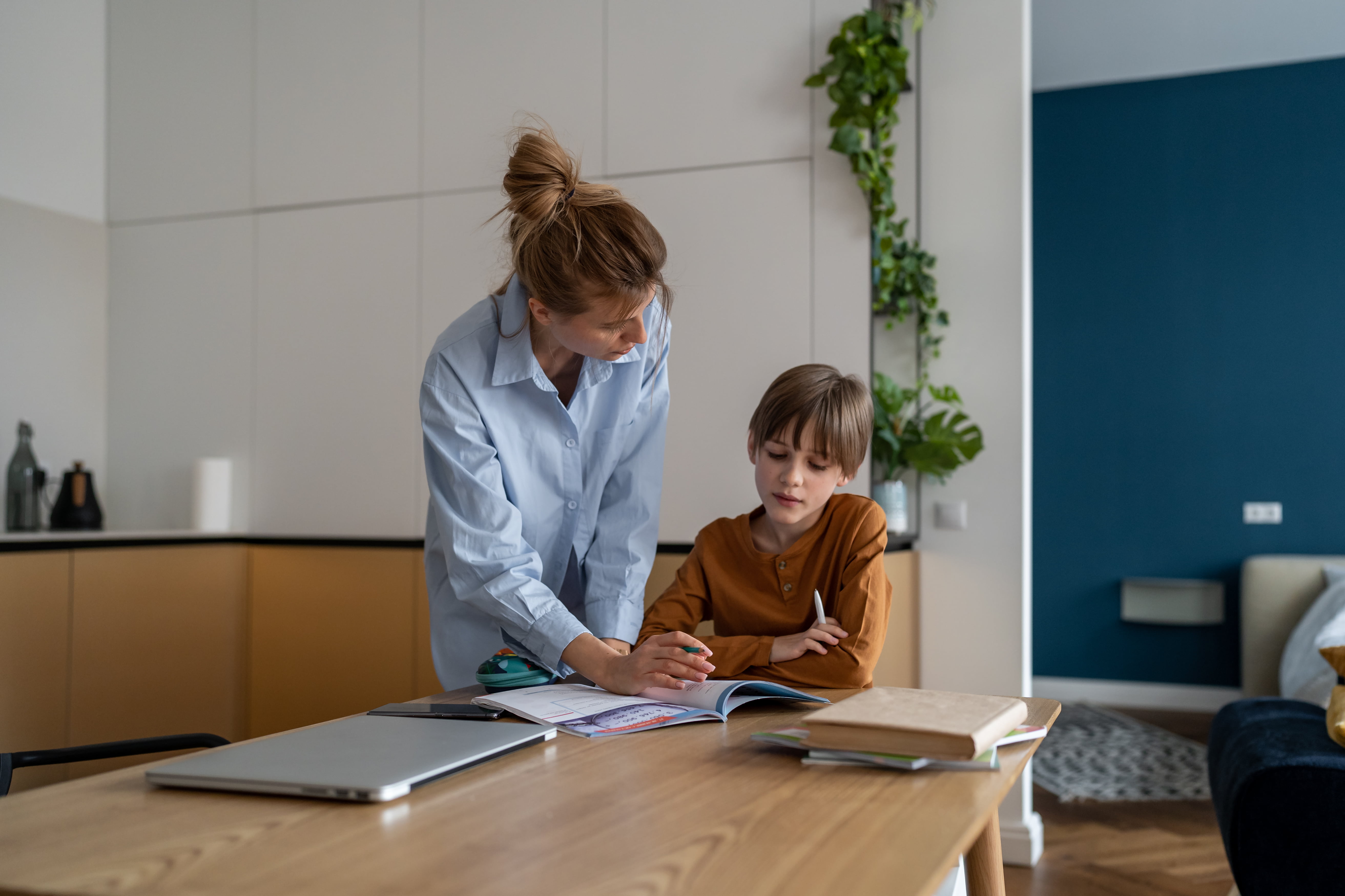 Happy child boy learning foreign language with private teacher tutor at home