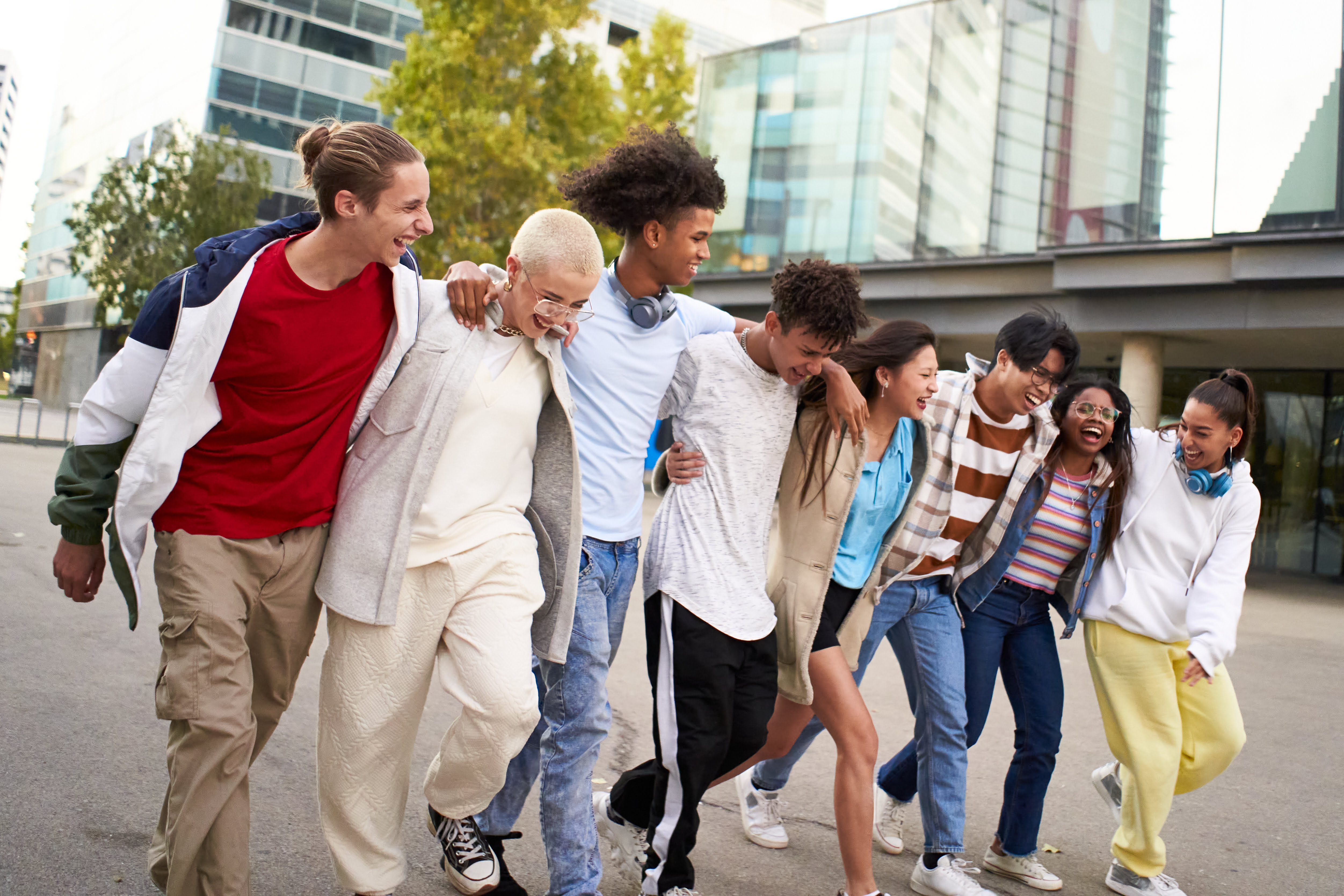 Multiracial friends group portrait outside. Happy multi cultural people smiling outdoors.