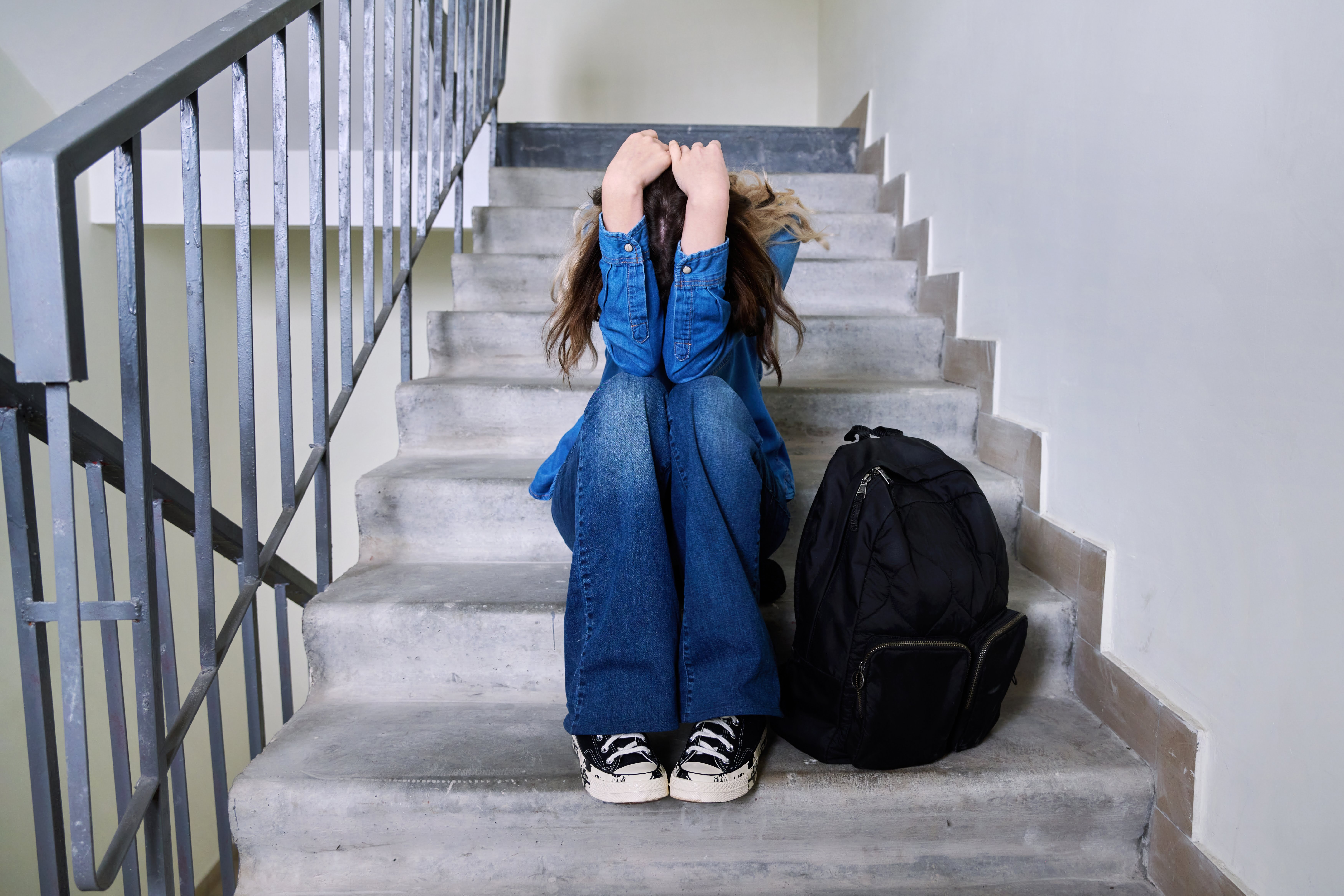 Sad frustrated young woman sitting on the steps