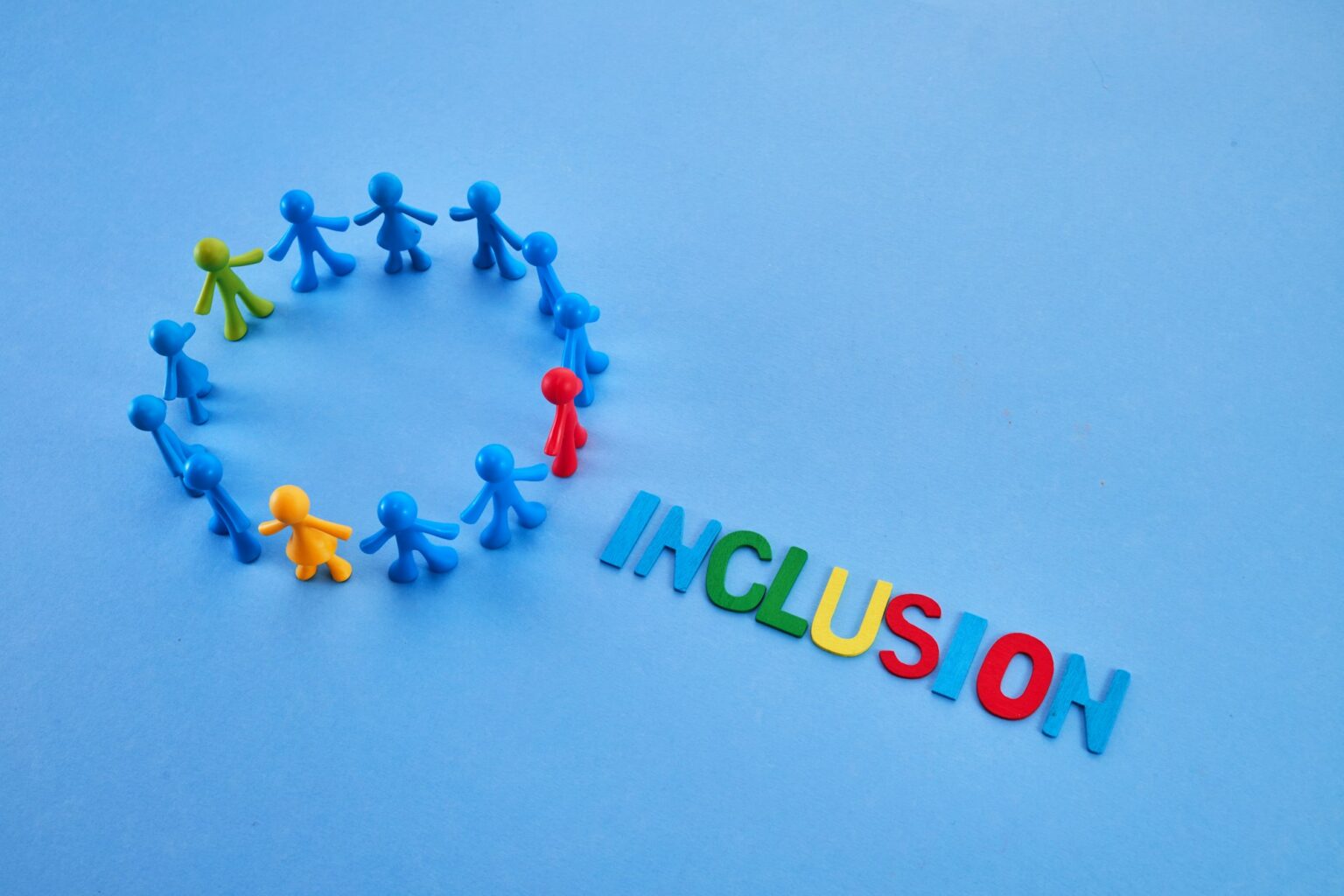 Diversity and inclusion concept. Colorful figurines on blue background