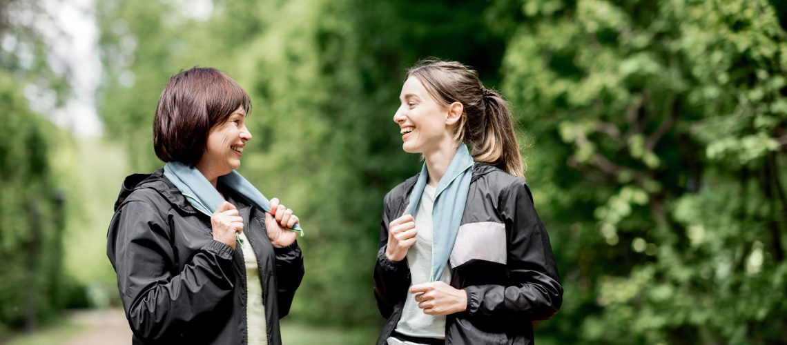 Two sports women talking in the park